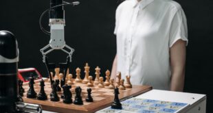 A Robotic Arm Picking up a Chess Piece on a Chessboard