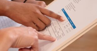 Persons Pointing at the Numbers on the Invoice