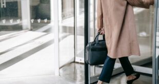 Anonymous businesswoman leaving through revolving door