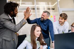 Men Doing High Five at the Office