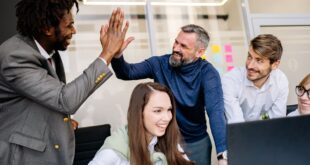 Men Doing High Five at the Office