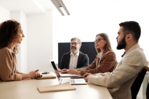 Business team meeting with diverse members collaborating in a modern office.